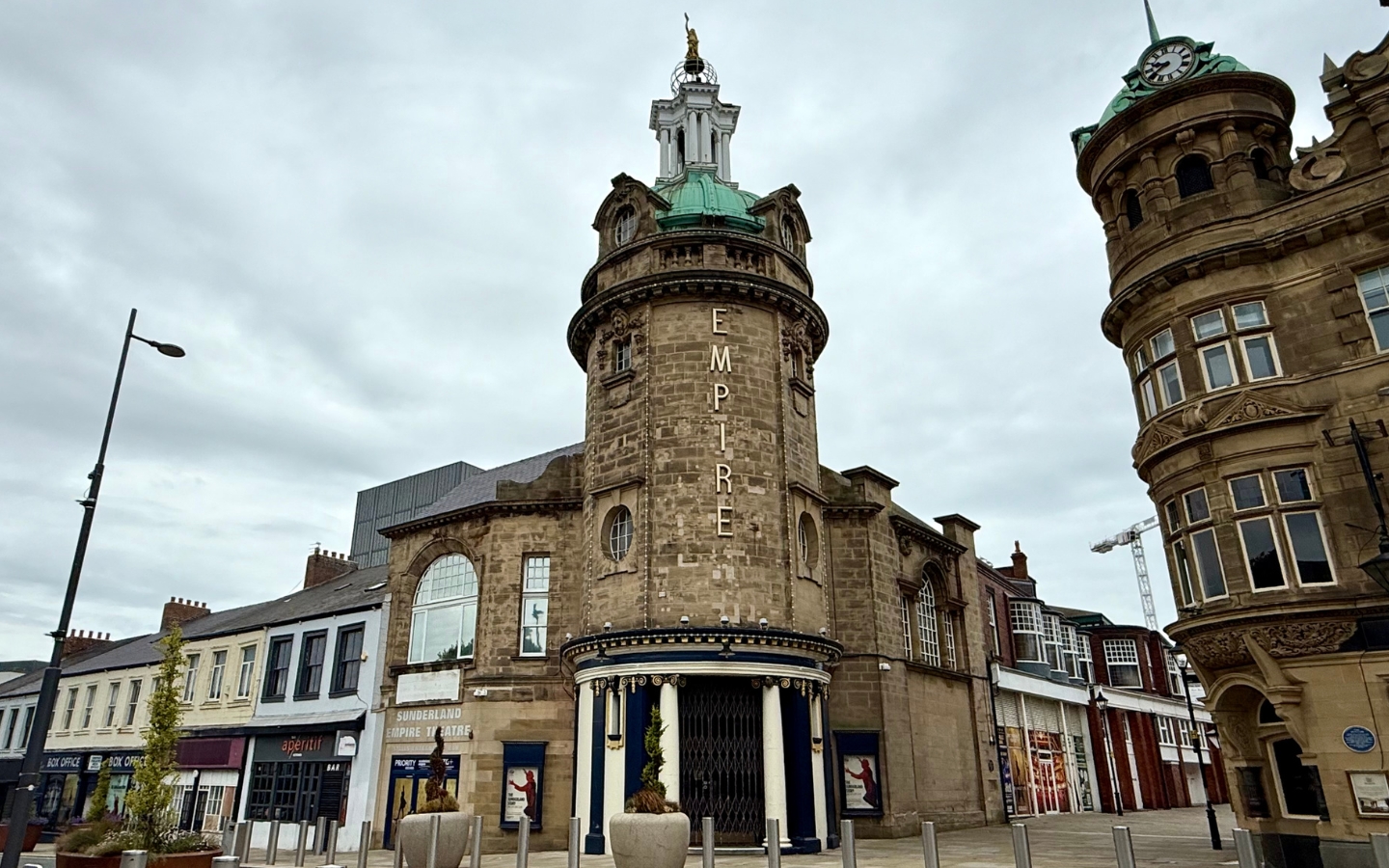 A grand theatre exterior on the corner of a street