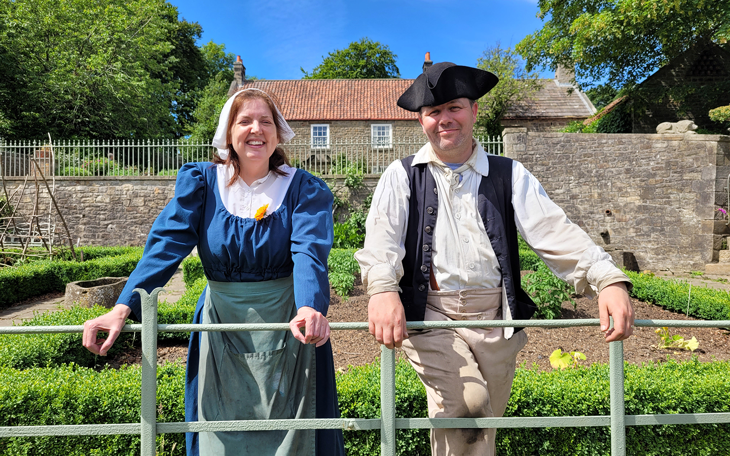 Pockerley Old Hall, at Beamish Musuem A man and woman stand in a kitchen garden dressed up in old fashioned clothes at Beamish Museum.