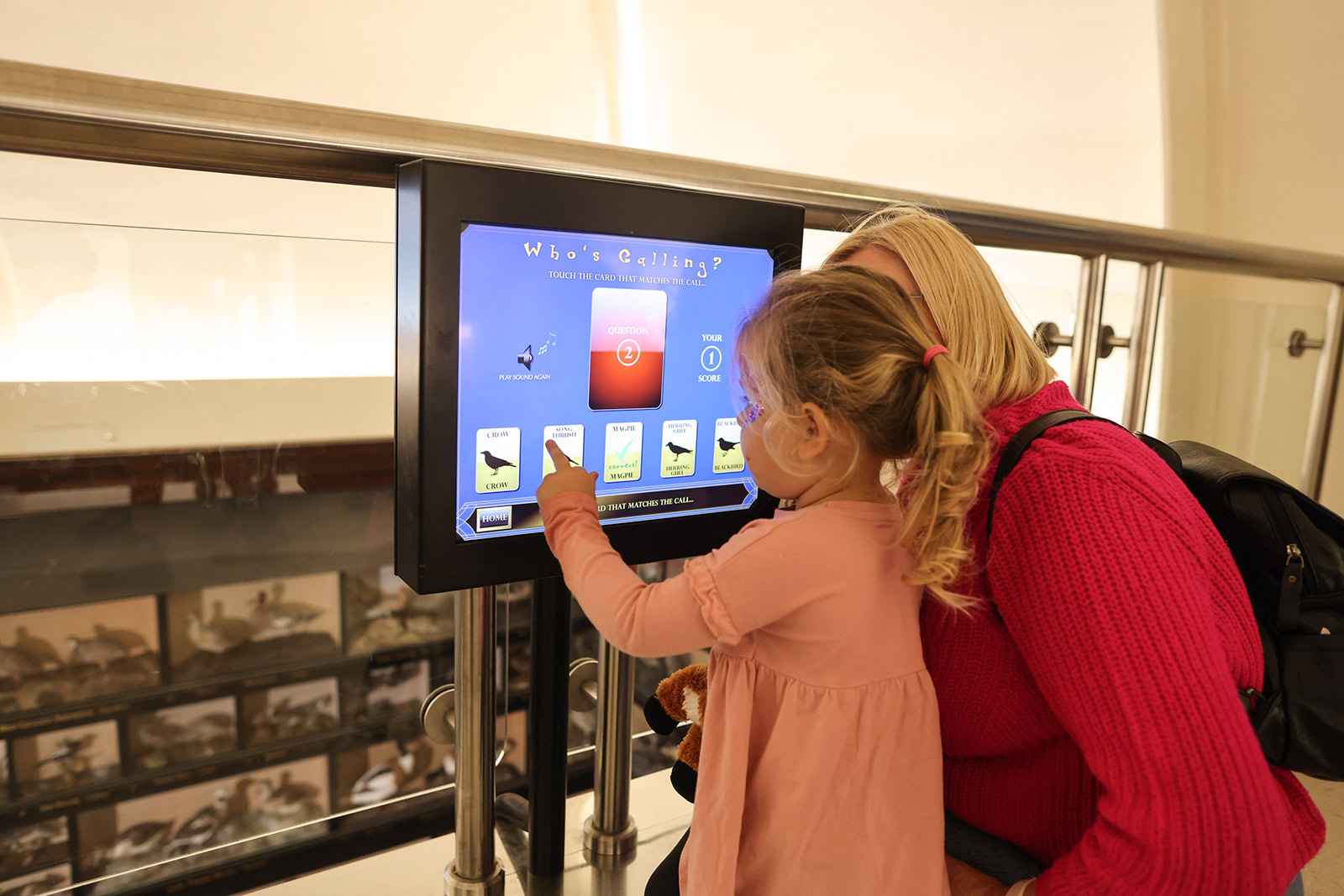 220903MBC-Dino-Event-at-Dorman-Museum_136-web A woman and young girl look at an interactive screen in a museum.