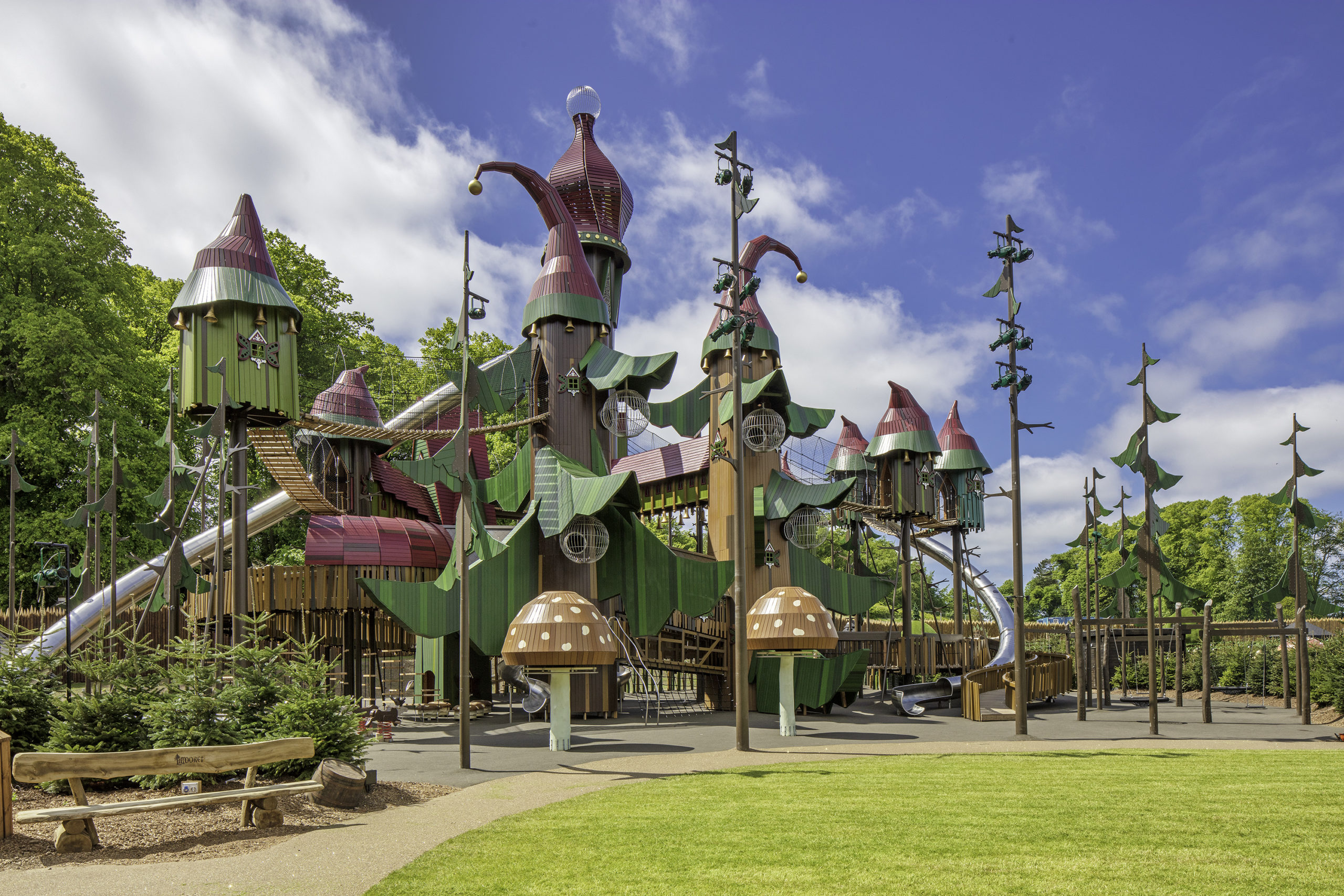 A large, elaborate play area with metal tube slides, giant toadstools and towers with domes that look like jester hats.