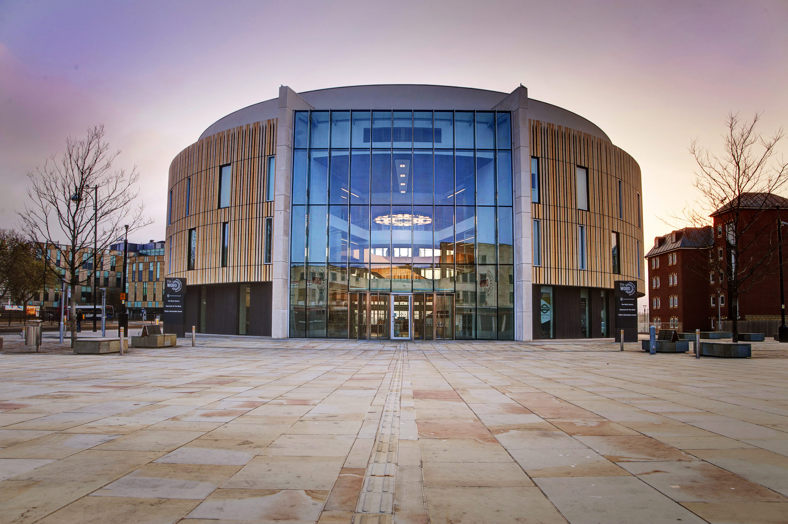 The exterior of The Word - a very modern circular building with a large glass entrance way.